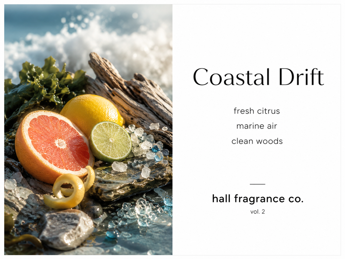 Fragrance label artwork for 'Coastal Drift' by hall fragrance co., featuring a split design: a left panel with citrus slices, seaweed, rocks, and ocean foam evoking a coastal scene; a right panel with the scent notes 'fresh citrus', 'marine air', and 'clean woods' on a white background.